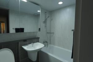 a bathroom with a sink and a toilet and a mirror at Sunset Stay Osong in Ch'ŏngnyong +17 photos