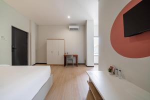 a bedroom with a bed and a table in a room at Cove Haven in Surabaya +14 photos