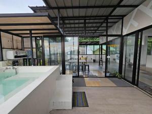 a large house with a swimming pool and glass walls at View Deck Private Pool in De La Paz