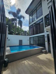 a house with a swimming pool in front of it at View Deck Private Pool in De La Paz