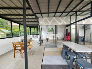 an open living room with a table and chairs at View Deck Private Pool in De La Paz