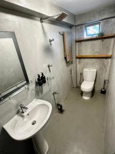 a bathroom with a sink and a toilet at surf dom hotel & restaurants in Ahangama +41 photos