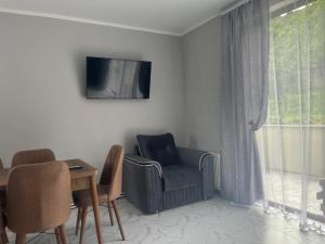 a living room with a chair and a table at Eva Grand House Dilijan in Dilijan