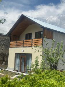 a small house with a balcony on top of it at Eva Grand House Dilijan in Dilijan