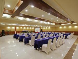 a large banquet hall with blue tables and white chairs at Marbella Place Anyer by Jayakarta in Kamasan +24 photos
