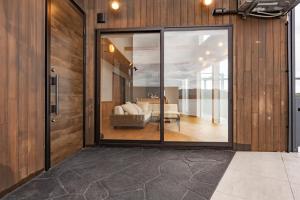 a large glass door leading to a living room at Namioto Villa YOSA in Hama
