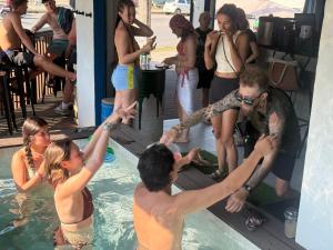 a group of people in a swimming pool at The Hangout Hostel Ao Nang in Ao Nang Beach