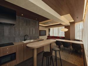 a kitchen with a counter and stools in a room at illi Haku Asakusa in Tokyo
