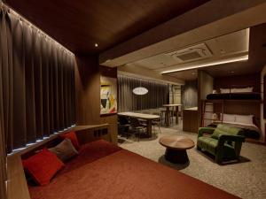 a bedroom with a bed and a living room with a desk at illi Haku Asakusa in Tokyo