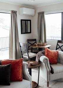 a living room with a couch and a table at Pembroke View in Carterton