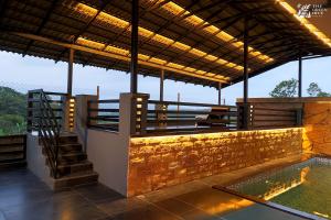 a house with a swimming pool and a roof at The Green Hive Villas in Belgaum