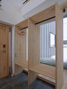 a room with a bed and a window at TsuTsu Furano by H2 Life in Furano