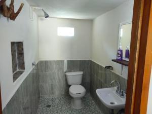 a bathroom with a toilet and a sink at koten Naj Cabanas in Xpujil