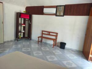a room with a chair and a tiled floor at koten Naj Cabanas in Xpujil
