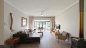 a living room with a couch and a table at The Dock in Clarens