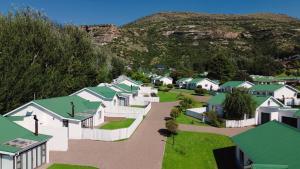 an aerial view of a village with houses and a mountain at The Dock in Clarens