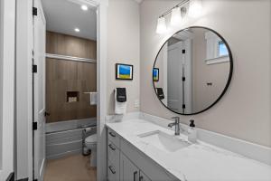 a white bathroom with a sink and a mirror at The Oceanview Retreat in Westport +95 photos