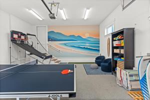 a room with a ping pong table and a painting at The Oceanview Retreat in Westport