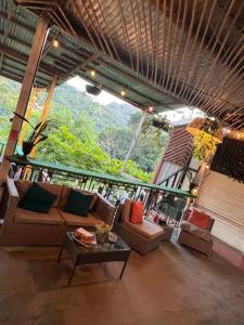 a living room with a couch and a table at CARIBbEAN Paradise Hotel in Lanquín