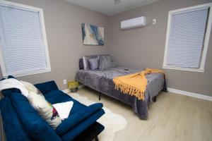 a living room with a bed and a couch at Home Sweet Home Bungalow in North Little Rock