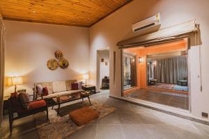 a living room with a couch and a tv at Brij Bageecha, Jaipur - IHCL SeleQtions in Jaipur