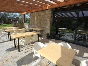 a group of tables and chairs in a patio at Villa in Býšovec near Harusak Ski Resort in Ujčov