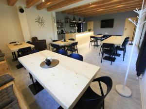 a restaurant with tables and chairs and a kitchen at Villa in Býšovec near Harusak Ski Resort in Ujčov +86 photos