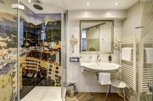 a bathroom with a sink and a shower at Hotel Goldener Adler, BW Signature Collection in Innsbruck +78 photos