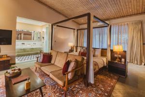 a living room with a bed and a couch at Brij Bageecha, Jaipur - IHCL SeleQtions in Jaipur +30 photos