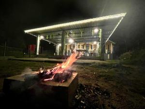 a fire pit in front of a building at night at Montavilla Eden Homestay Sittong in Kurseong
