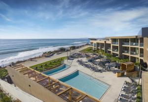 an aerial view of a resort with a swimming pool and the ocean at Alila Marea Beach Resort Encinitas, a Hyatt Resort in Encinitas