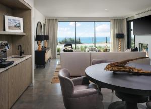 a living room with a couch and a table at Alila Marea Beach Resort Encinitas, a Hyatt Resort in Encinitas