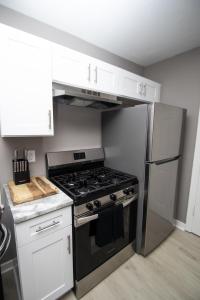 a kitchen with a stove and a refrigerator at Home Sweet Home Bungalow in North Little Rock