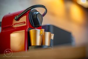 a red suitcase is sitting on a table at Studio neuf et moderne centre historique in Chambéry
