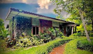 a brick house in the middle of a field at Sarita Resort Villa in Kampong Huaibū