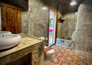 a bathroom with a sink and a toilet at Sarita Resort Villa in Kampong Huaibū
