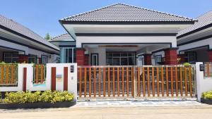 a house with a gate in front of it at Aroya Pool Villa Hatyai in Ban Thung Ri