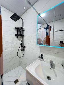 a bathroom with a sink and a mirror at White House Apartment in Samarkand +6 photos