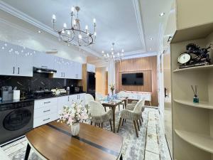 a kitchen and dining room with a table and chairs at White House Apartment in Samarkand