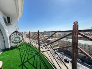 a balcony with a view of a city at White House Apartment in Samarkand
