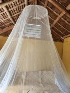 a mosquito net hanging from a ceiling at Guarin House in Sipating