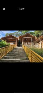 a staircase leading up to a building with wooden structures at Guarin House in Sipating