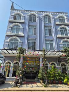 a large building with a store in front of it at Sun Horizon Hotel - Phnom Penh in Phnom Penh
