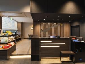 a restaurant with a cash register and a counter at Onomichi Daiichi Hotel in Onomichi