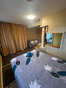a bedroom with a bed with blue flowers on it at Apartment Slađana i Luna in Subotica