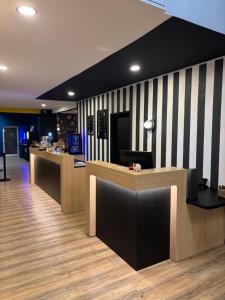 a lobby with black and white striped wall at ibis Avallon in Magny