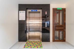 an elevator with a colorful mat in front of it at Treebo Premium Silva Lux in Wayanad +51 photos