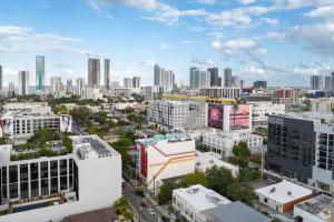 an aerial view of a city with tall buildings at Voy House Wynwood with Rooftop Pool in Miami