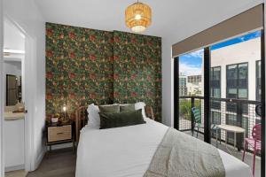 a bedroom with a bed and a large window at Voy House Wynwood with Rooftop Pool in Miami +73 photos