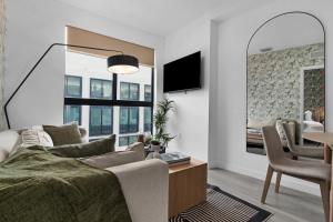 a living room with a bed and a dining room at Voy House Wynwood with Rooftop Pool in Miami